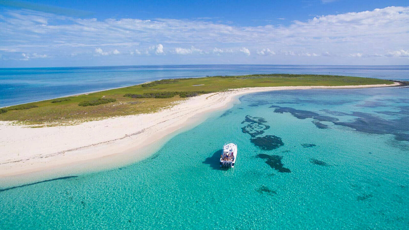 Small boat at a white sandbar on a private boat day in Turks and Caicos