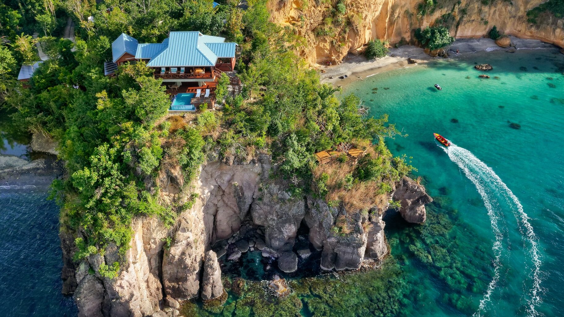 Clifftop villa deck at Secret Bay Dominica with a private plunge pool and the Caribbean Sea below