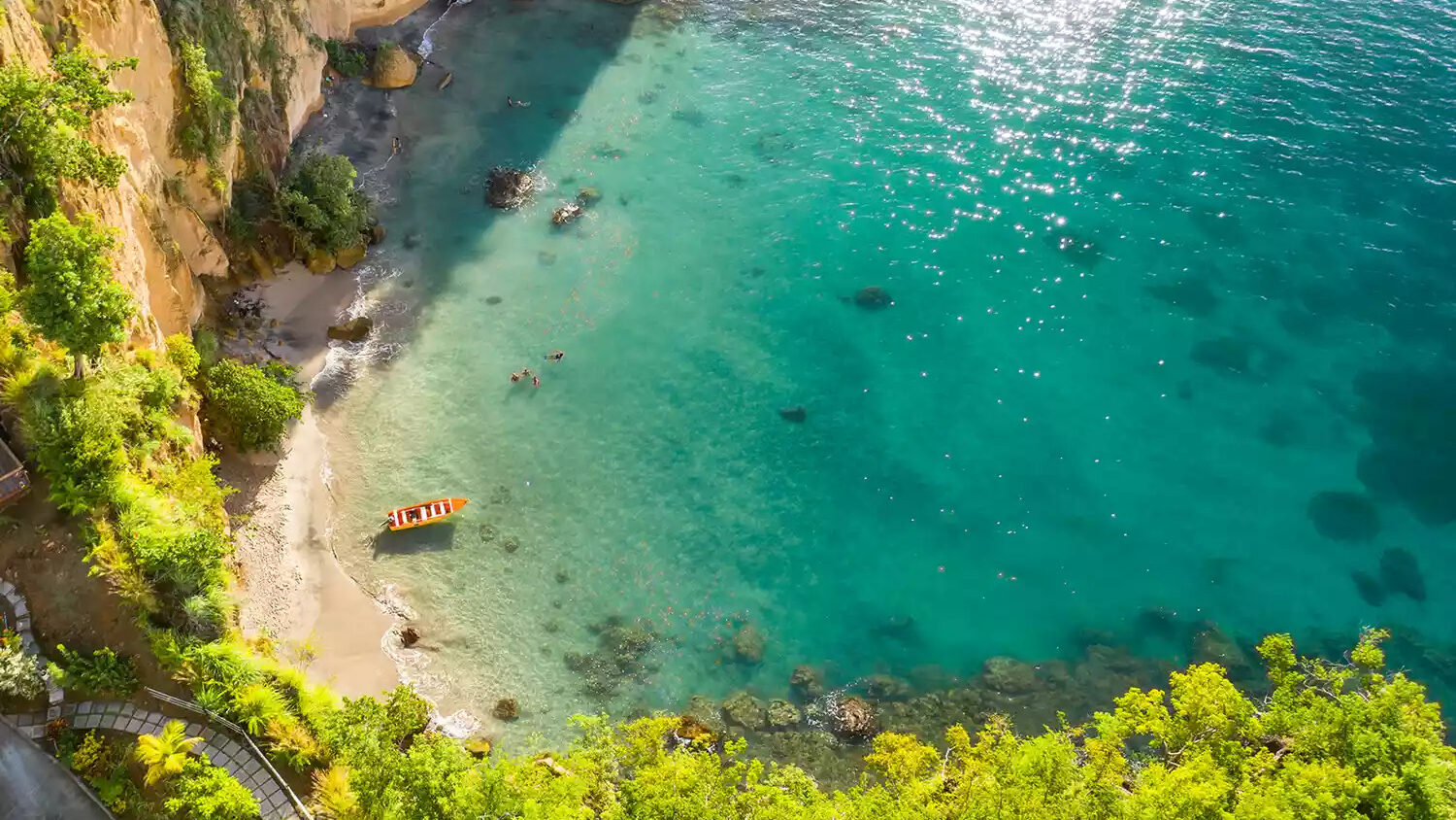 Secret Bay Dominica secret beach cove with small boat